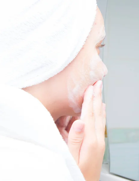 Girl Towel Her Head White Coat Washes Foam Her Face — 스톡 사진