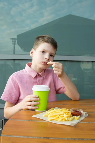 Menino Senta Mesa Comendo Batatas Fritas Com Ketchup Beber — Fotografia de Stock