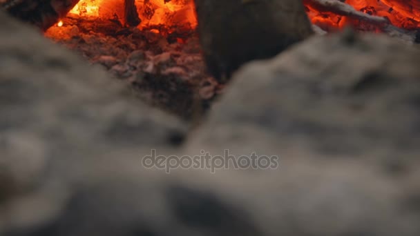 DOLLY MOTION: Red flame heats the old pot. Cooking outdoors. Cooking on fire. Travel Gear. Tourist pot on the fire. — Stock Video