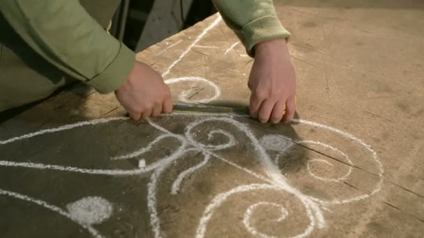 Close-up hand of a young blacksmith who measures and sign sketch on the table — Stock Video