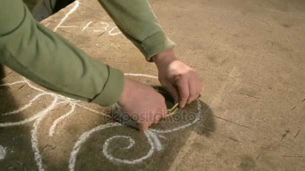 Close-up van de hand van een jonge smid die maatregelen en teken schets op tafel — Stockvideo