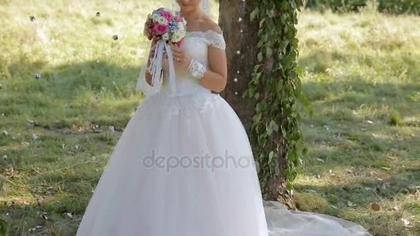 Beautiful bride with a bouquet in hand — Stock Video