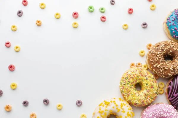 Abstract colorful donuts bakery, sweet concept background with place for text. Top view. Glazed donuts on color background.