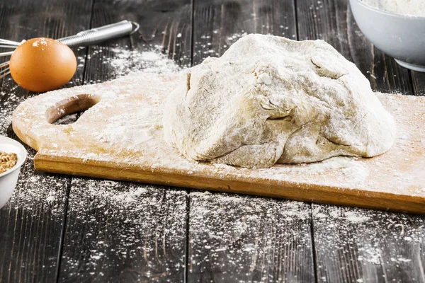 Flour and kitchen utensils whisk, baking dish, rolling pin with eggs on the table. Baking, cooking concept, top view with place for text.