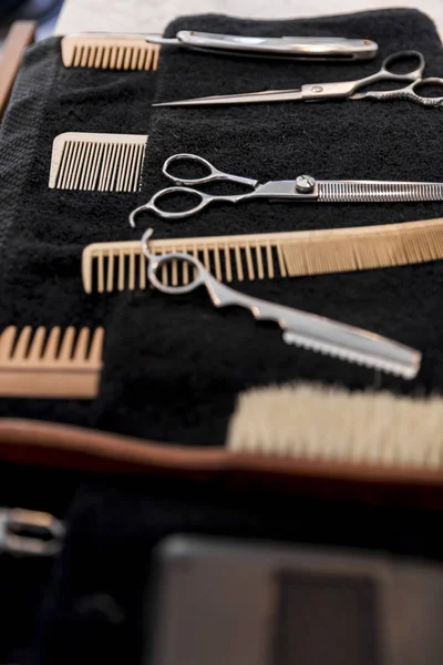Various tools for the care of a beard and hairstyle. Scissors, razors, combs. Shaving concept. Barbershop.