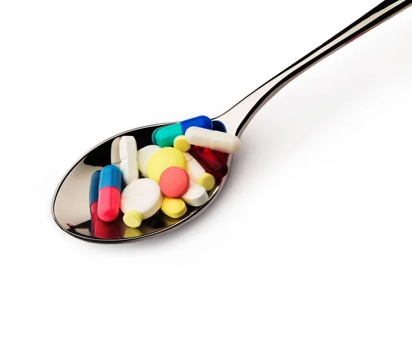 Enfermedad. Un montón de pastillas en cuchara —  Fotos de Stock