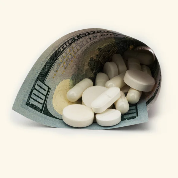 White pills with money. Health costs a lot