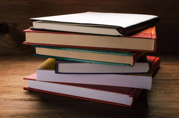 Стопка книг на деревянном столе — стоковое фото