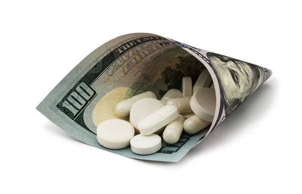 Bílé pilulky s penězi. Zdravotnictví stojí hodně — Stock fotografie