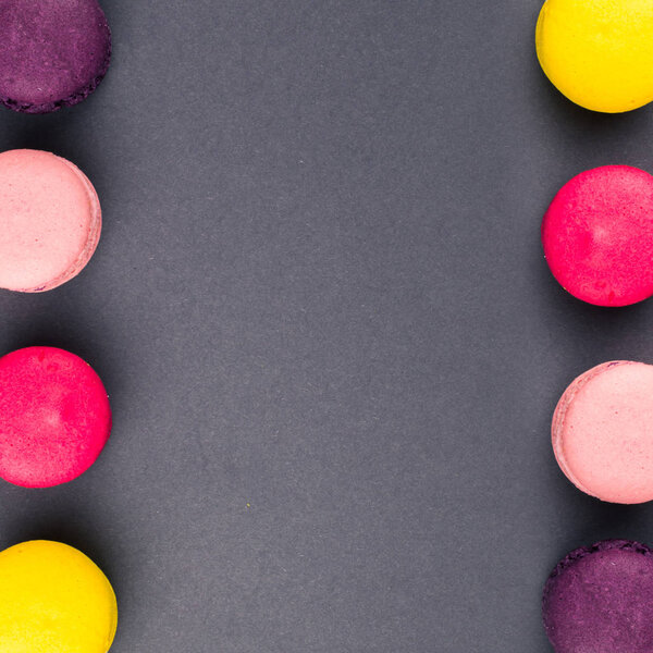 Colourful french macaroons on the grey background, Top view. Square