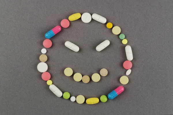 Unhappy smile created from colored pills. Medical concept — Stock Photo, Image