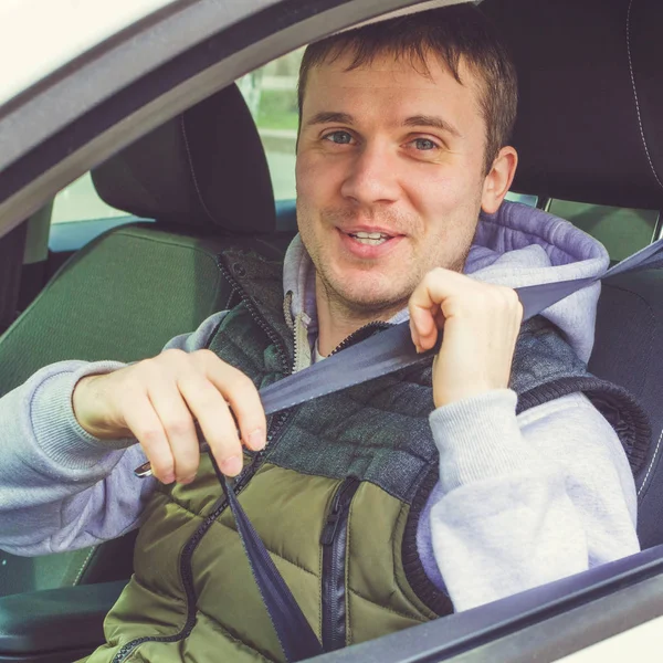 Young man fasten Safety belt. Safe driving Stock Photo by ©MasAnyanka