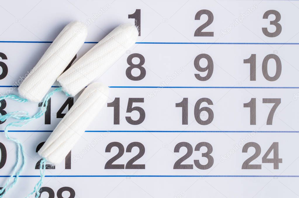 Menstrual calendar with tampons and pads. Menstruation cycle. Hygiene and protection