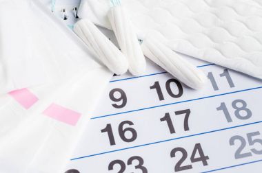 Menstrual calendar with tampons and pads. Menstruation time. Hygiene and protection clipart