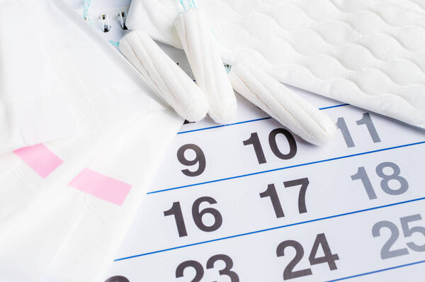 Menstrual calendar with tampons and pads. Menstruation time. Hygiene and protection