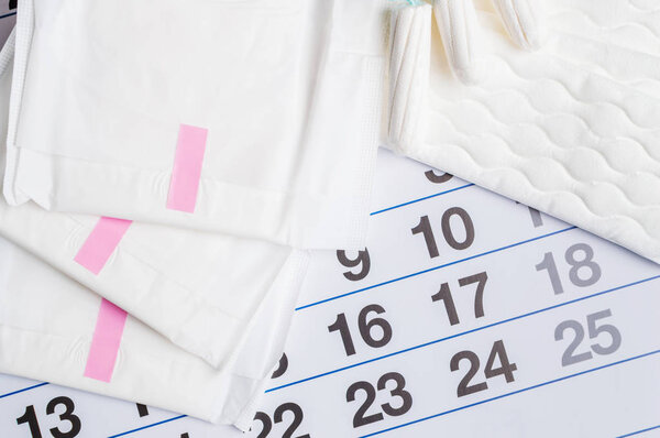 Menstrual calendar with tampons and pads. Menstruation time. Hygiene and protection