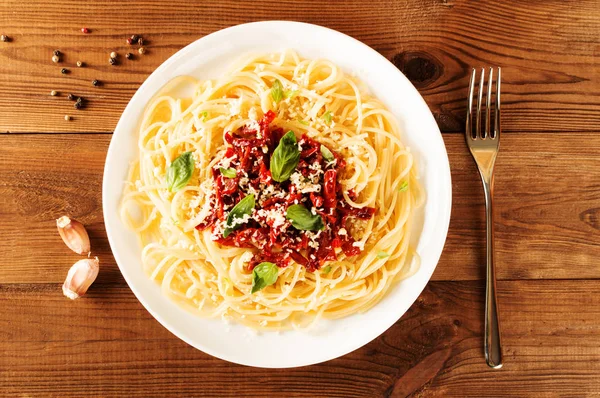 İtalyan yemek - güneşte kurutulmuş domates ve fesleğen ile makarna. Üstten Görünüm