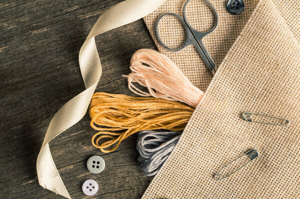 Accessories for hobbies: tape, scissors, needle and pin. Flat lay composition