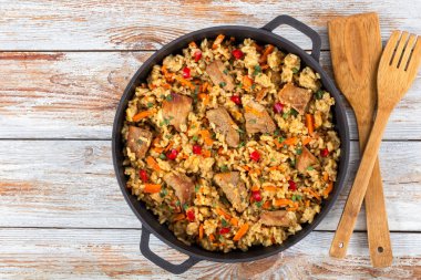 Homemade prepared paella with meat, pepper, vegetables and spice clipart