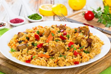 paella with meat, pepper, vegetables and spices on dish clipart