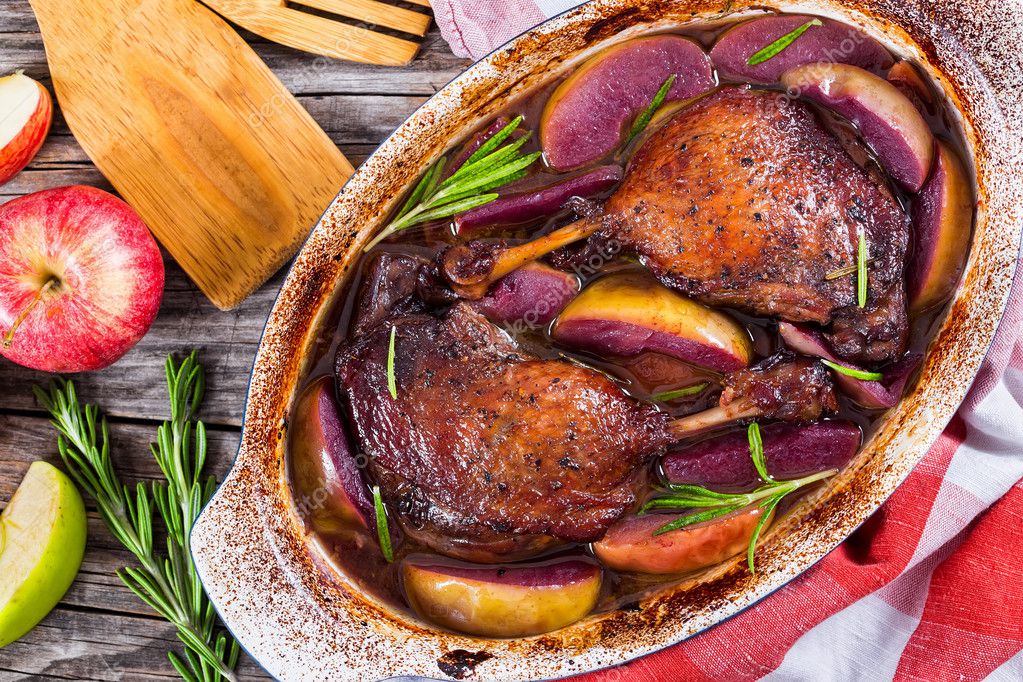 Two roasted duck legs grilled in red wine and apple Stock Photo by