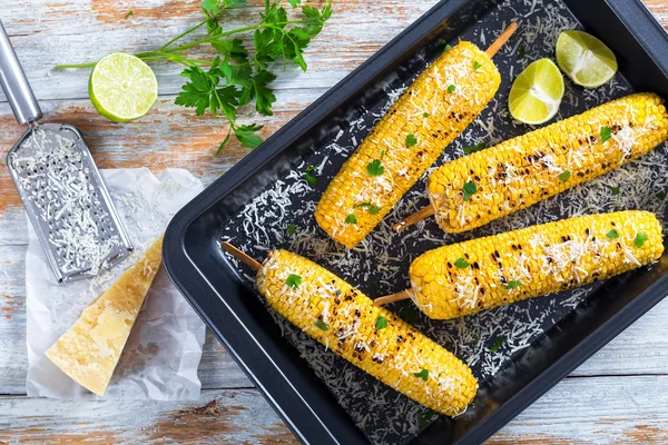 Grilled corn sprinkled with parsley and grated parmesan — Stockfoto