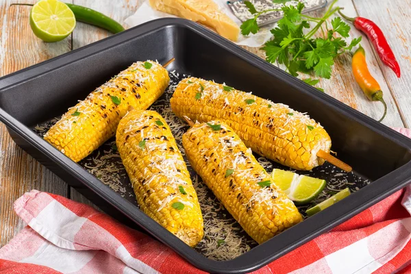 Grilled corn sprinkled with parsley and grated parmesan — Stock Photo, Image