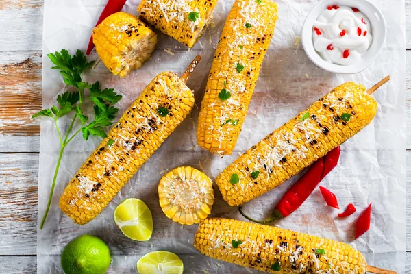 Sabroso maíz a la parrilla sobre mazorca espolvoreada con perejil y parmesano — Foto de Stock