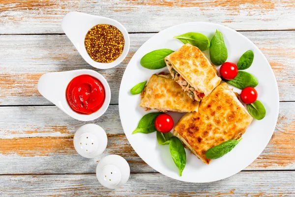 fried flatbread wraps Stuffed with meat on white dish
