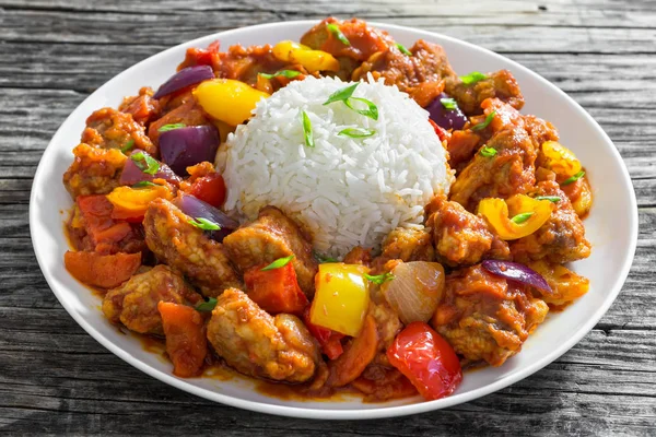 Rice with Sweet and Sour fried pork chunks with vegetables Stock Photo