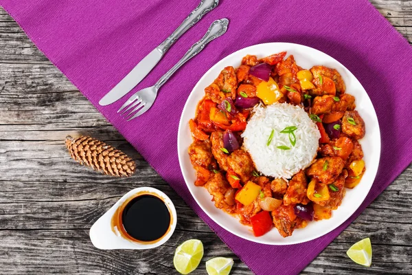 Rice with Sweet and Sour fried pork chunks with vegetables Stock Picture