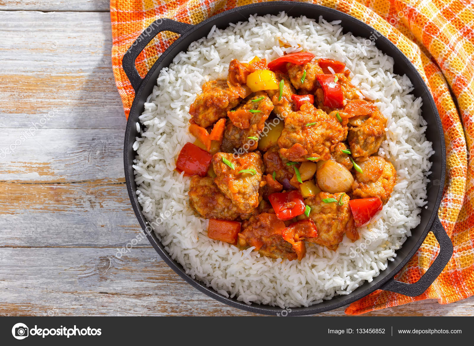 Rice and pork chunks with vegetables, view from above Stock Photo by