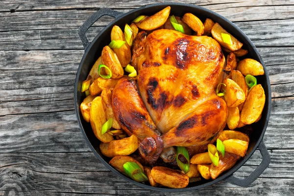 golden crispy skin chicken grilled in oven with potato wedges