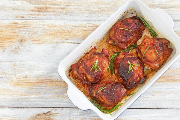 Delicious chicken thigh roasted in baking dish with rosemary — Stock Photo, Image