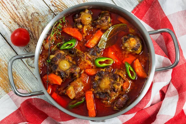 Beef tail stew with vegetables, thyme, red wine — Stock Image Beef tail stew with vegetables, thyme, red wine Stock Image