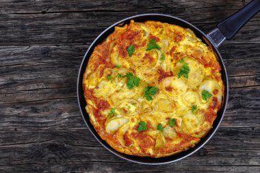 spanish Tortilla in skillet on table clipart