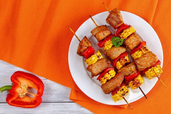 Grilled pork meat with pieces of corn cobs — Stock Photo, Image