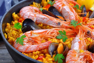 seafood paella with king prawns, mussels clipart