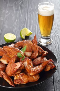 chicken wings with beer in a glass clipart