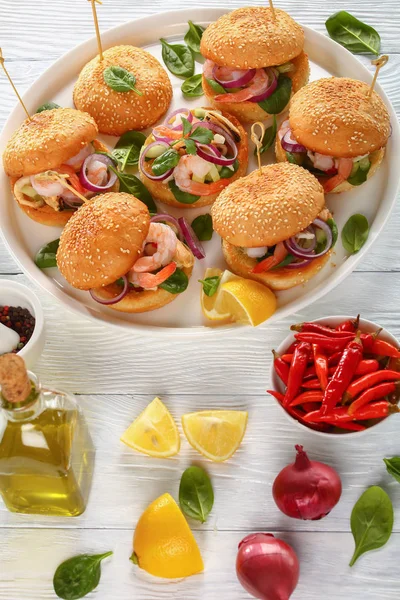 Grilled burgers with seafood on dish — Stock Photo, Image