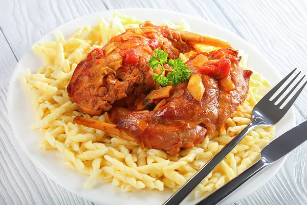 Stewed Rabbit legs served with pasta — Stock Photo, Image