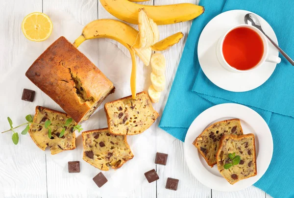 Banana bread on table with cup of tea — Stock Photo, Image