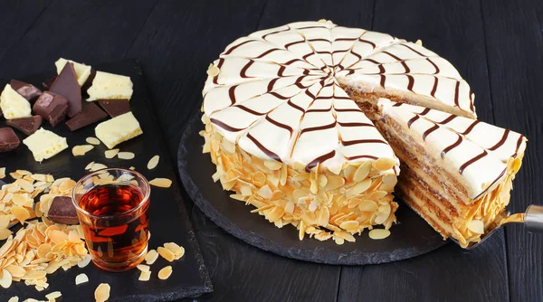 Whole esterhazy torte and a slice on spatula — Stock Photo, Image