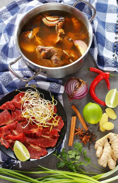 Hot beef bone broth in a stainless pan — Stock Photo, Image