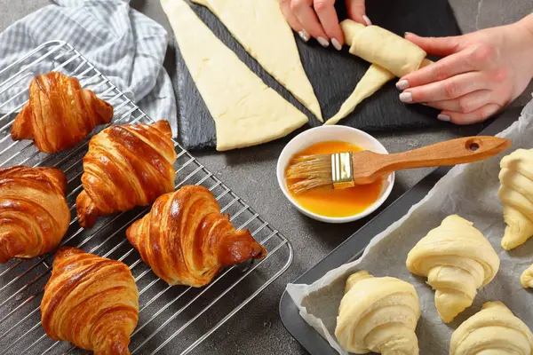 Woman is shaping dough to bake French croissants — Stock Photo, Image