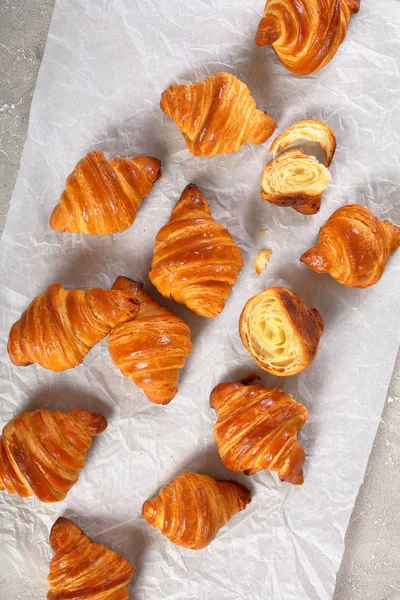 French croissants with flaky texture on paper — Stock Photo, Image