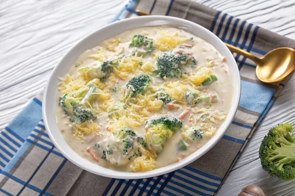 Cheesy broccoli soup in a white bowl — Stock Image Cheesy broccoli soup in a white bowl Stock Image