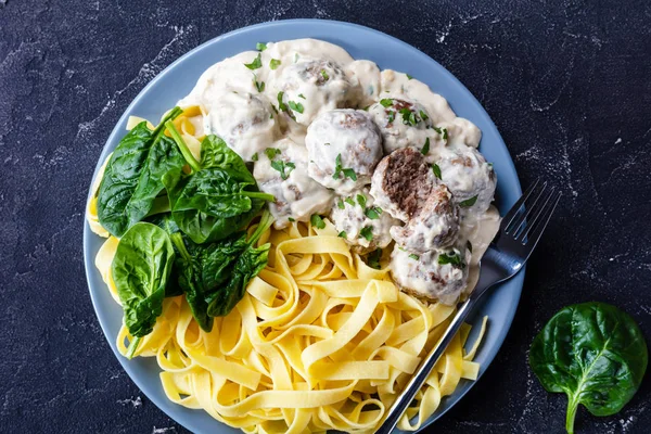 Swedish meatballs with egg noodle and spinach
