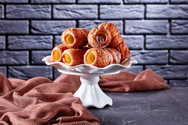 Hungarian pastry chimney cake on a white plate — Stock Photo, Image