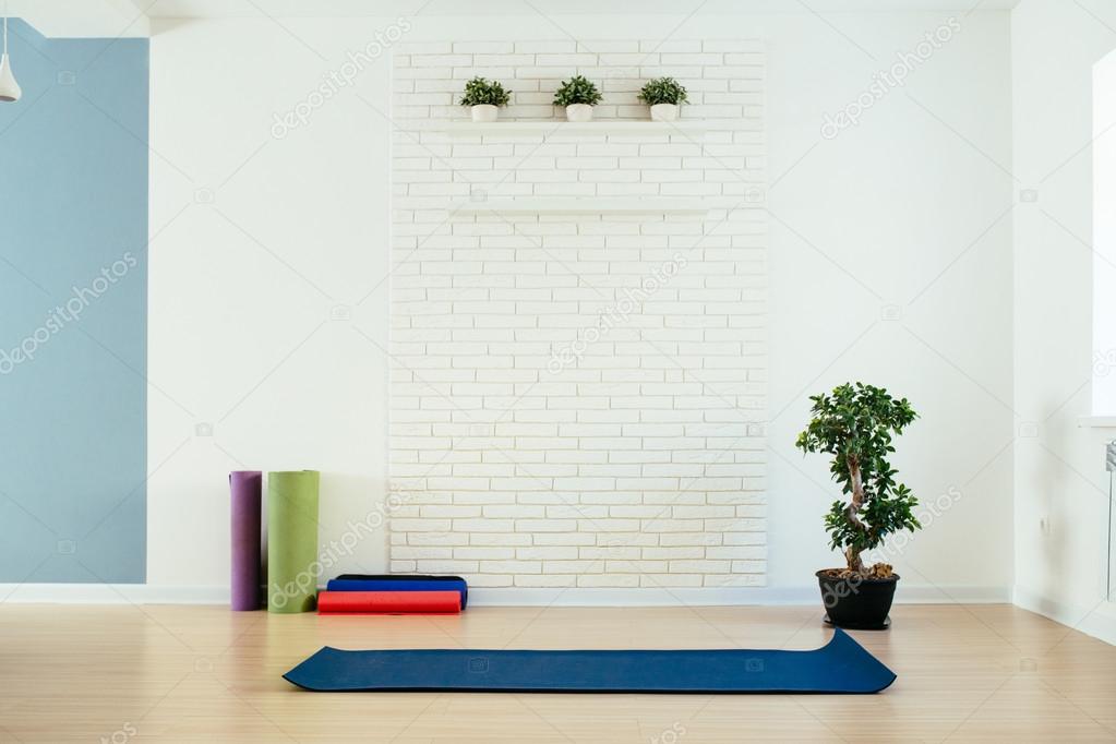 Yoga Room With Mat And White Brick Wall Stock Photo